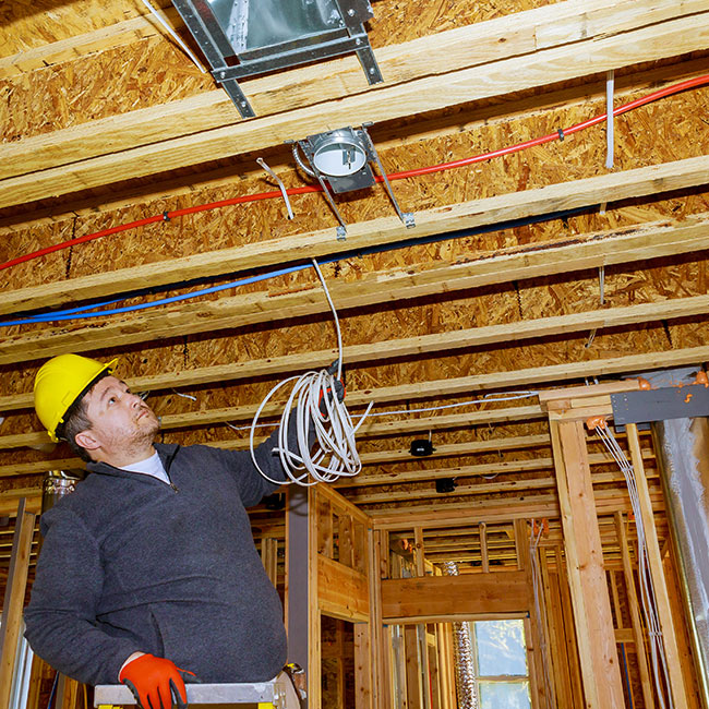 electrician-installing-ceiling-wires-during-new-construction-electrical-installation-pennsauken-nj